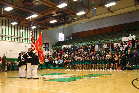The ROTC presents the flags at a pep assembly before a big game.