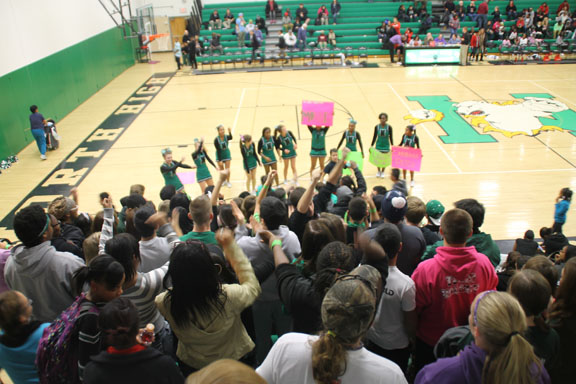 The North High cheerleaders  pump up the student section at a home game against the Indianola Indians.