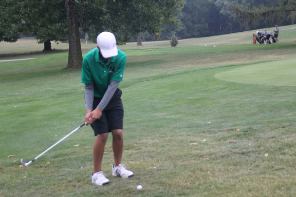 Freshman Michael Sunga chips onto the green at Grandview Golf Course.