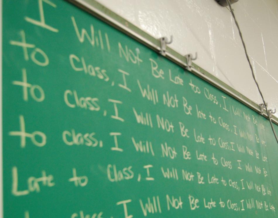 The quote, I will NOT be late to class repeatedly written on the chalkboard.