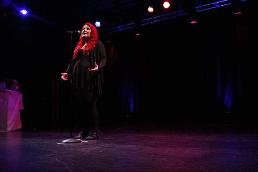 Senior, Leah Waughtal, performs at the Temple of Performing Arts at the Teen Poetry Slam.