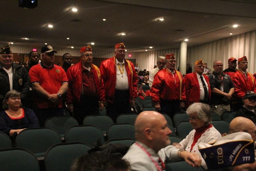 Veterans stand to be honored for their service in the Marine Core.