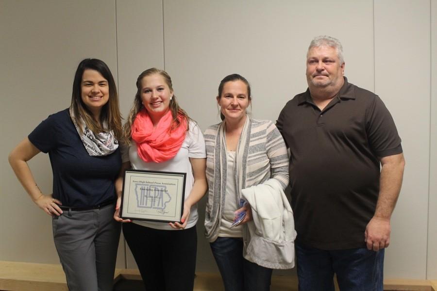 Jones showing off her new award with her parents and advisor on Tuesday, November 3rd at the Des Moines school board meeting.