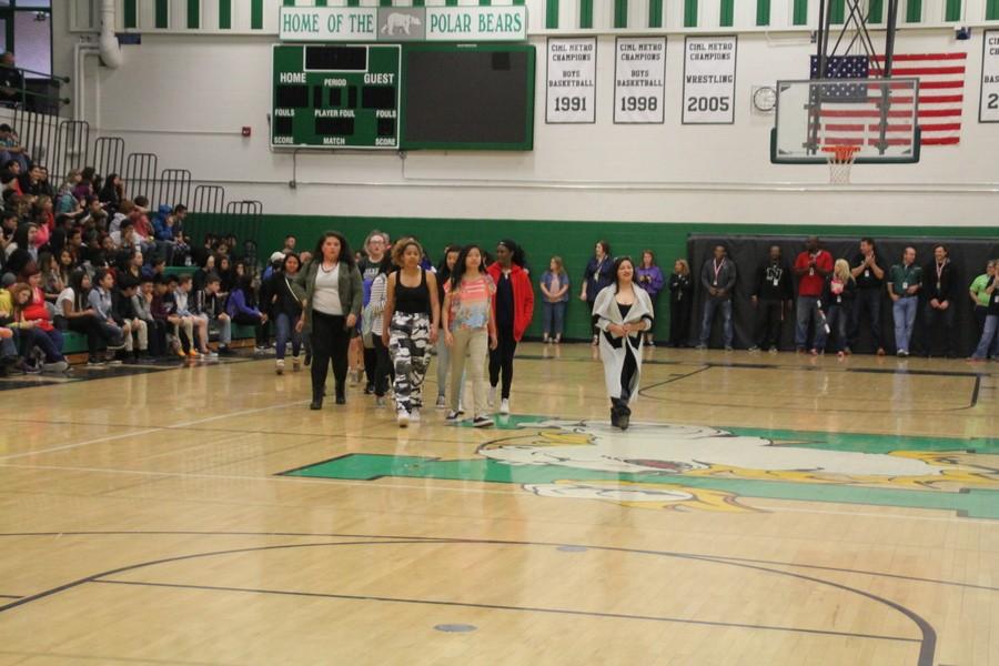 The NHS girls tennis team proudly walks across the gym when they are announced. 