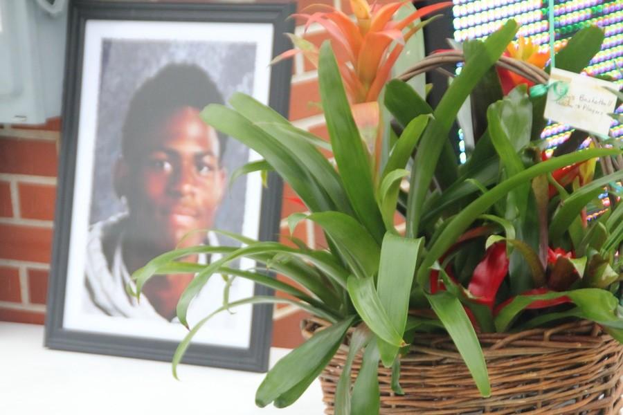A+basket+of+flowers+is+placed+next+to+the+memorial+of+Kendall+Foster.