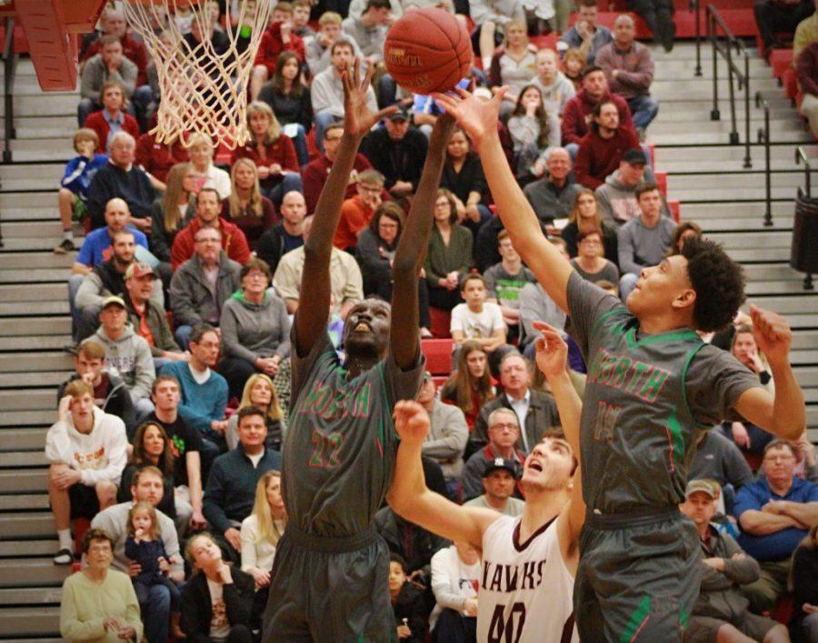 Senior, Jal Bijiek and Junior, Jaihon McCaleb jump up for a rebound after an Ankeny Hawk misses the free throw.
