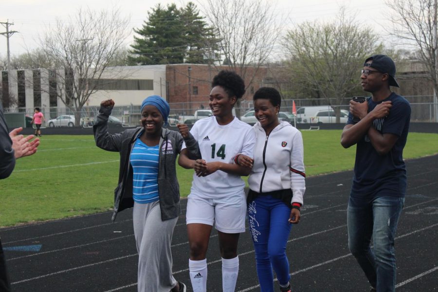 Senior+Tuyishime+Florance+walking+with+friends+towards+her+coach+and+teammates.