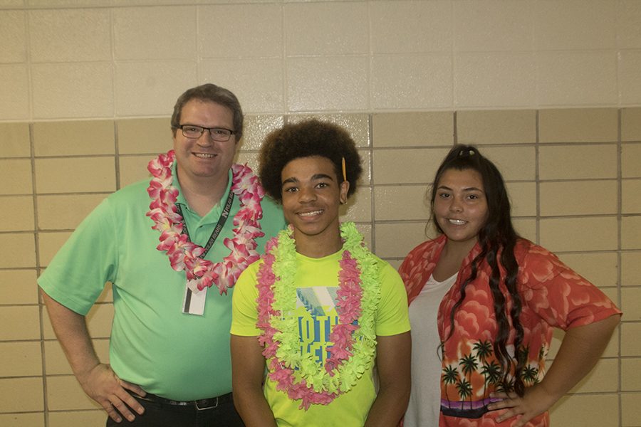 English teacher Nathan Fredericks and juniors Greg Oats and Natalia Guerrero celebrate Tropical Tuesday.